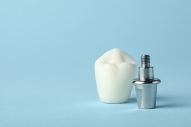 Photo of Abutment and crown of dental implant on light blue background, closeup. Space for text