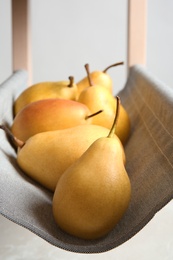 Photo of Ripe yellow pears on fabric shelf, closeup