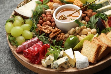 Photo of Different tasty appetizers on grey table, closeup
