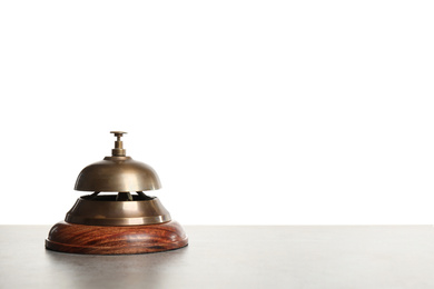 Hotel service bell on grey stone table against white background