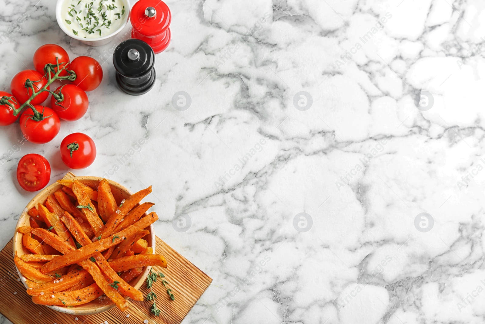 Photo of Flat lay composition with bowl of sweet potato fries on marble background. Space for text