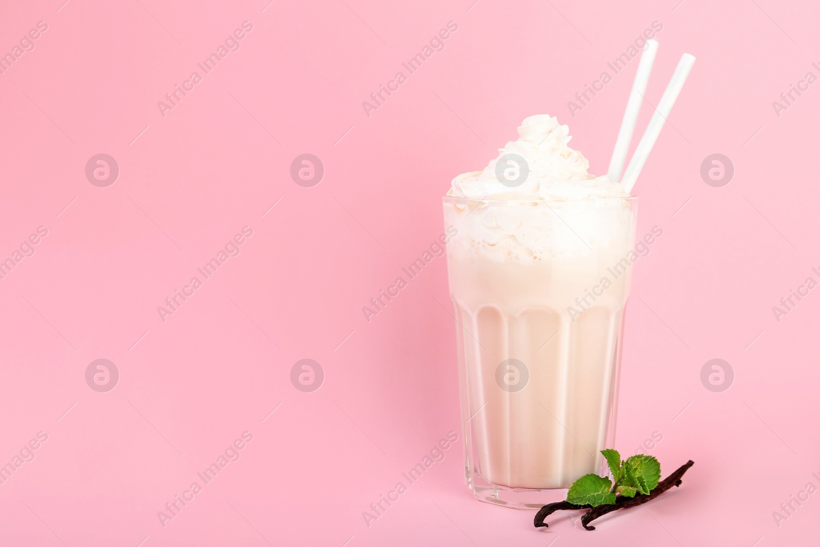 Photo of Glass with vanilla milk shake on color background