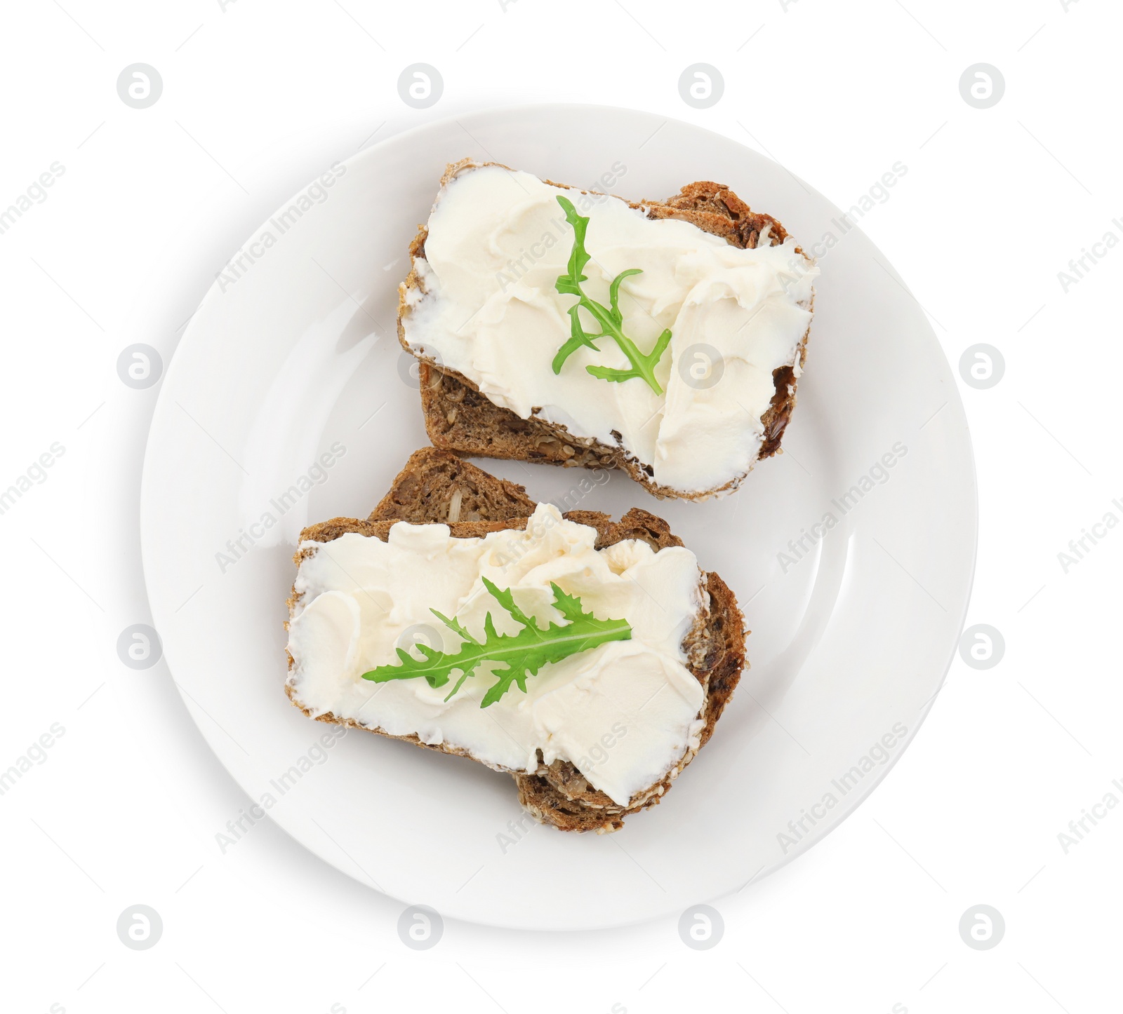 Photo of Bread with cream cheese and arugula on white background, top view