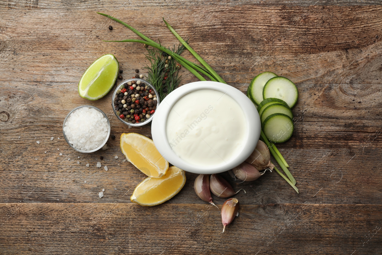 Photo of Flat lay composition with cucumber sauce and ingredients on wooden background