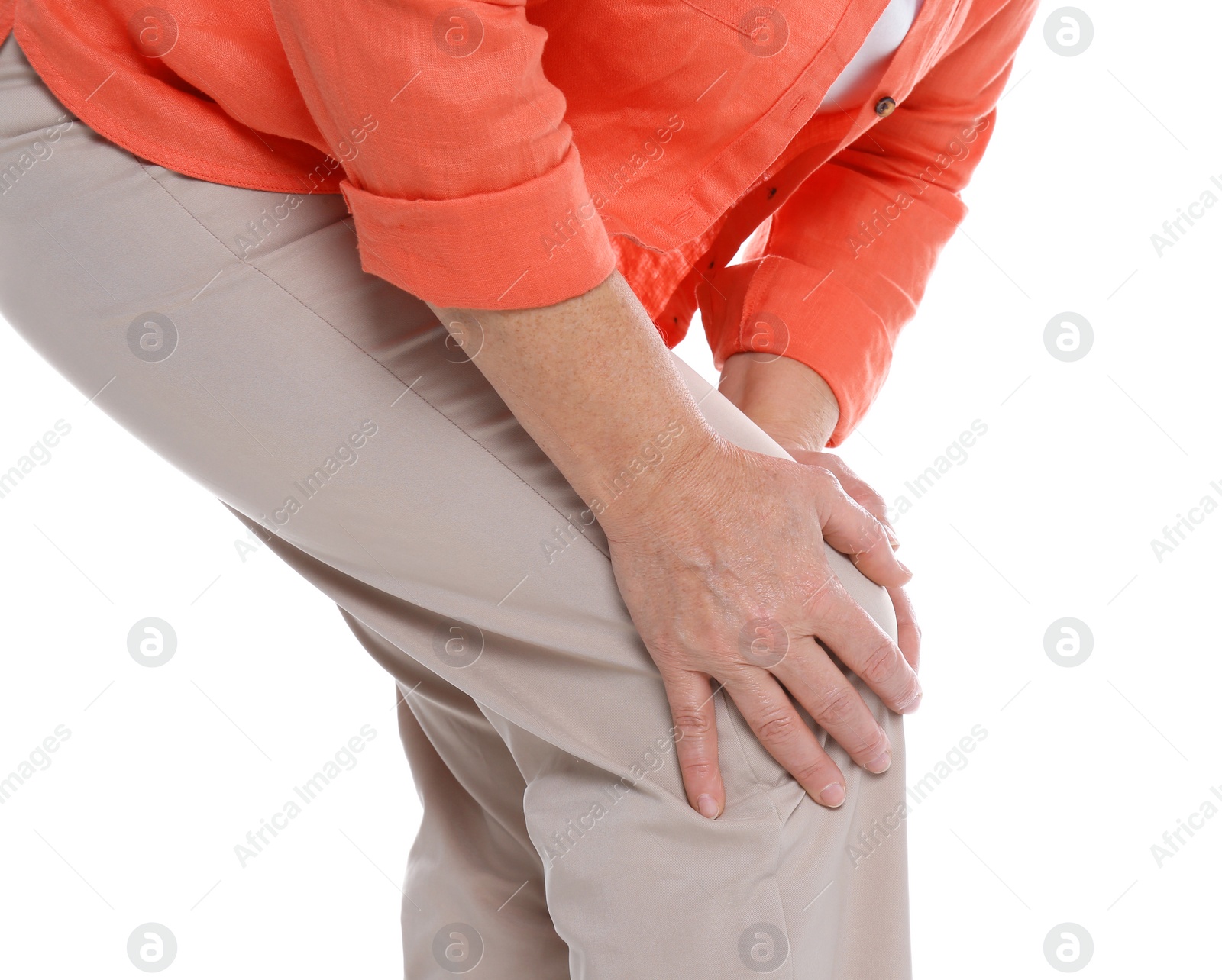 Photo of Woman suffering from knee pain on white background, closeup