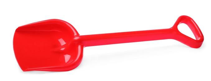 Red plastic toy shovel isolated on white