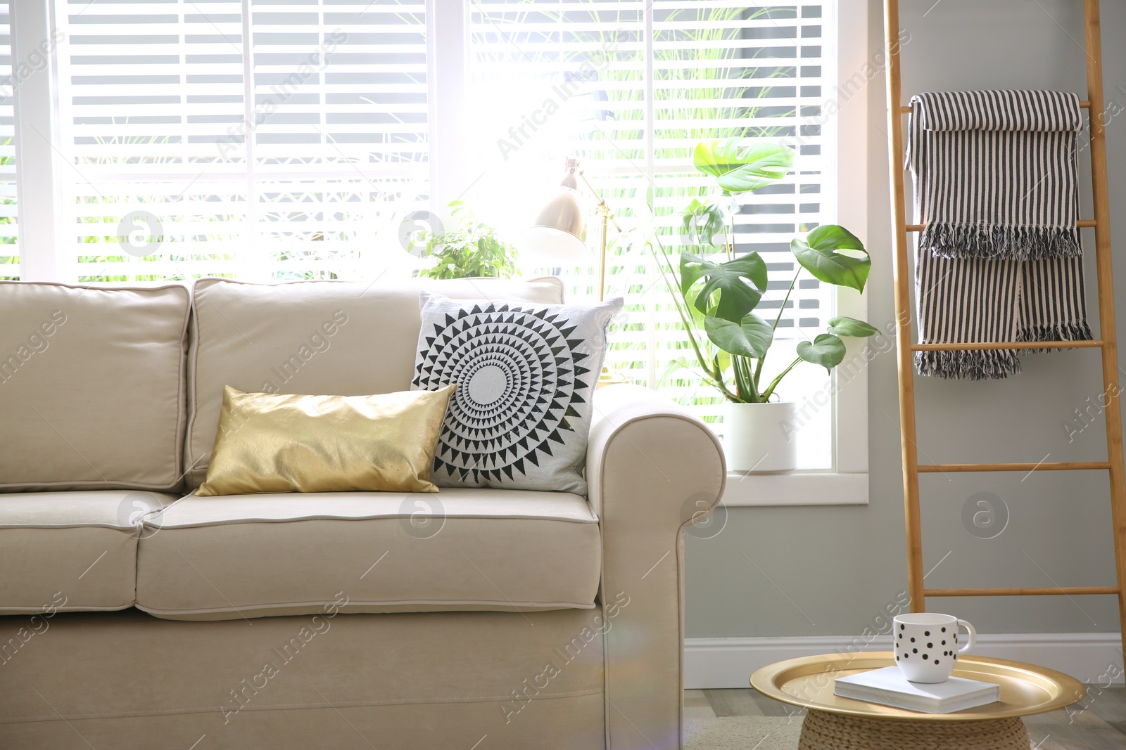 Photo of Stylish beige sofa in modern living room interior