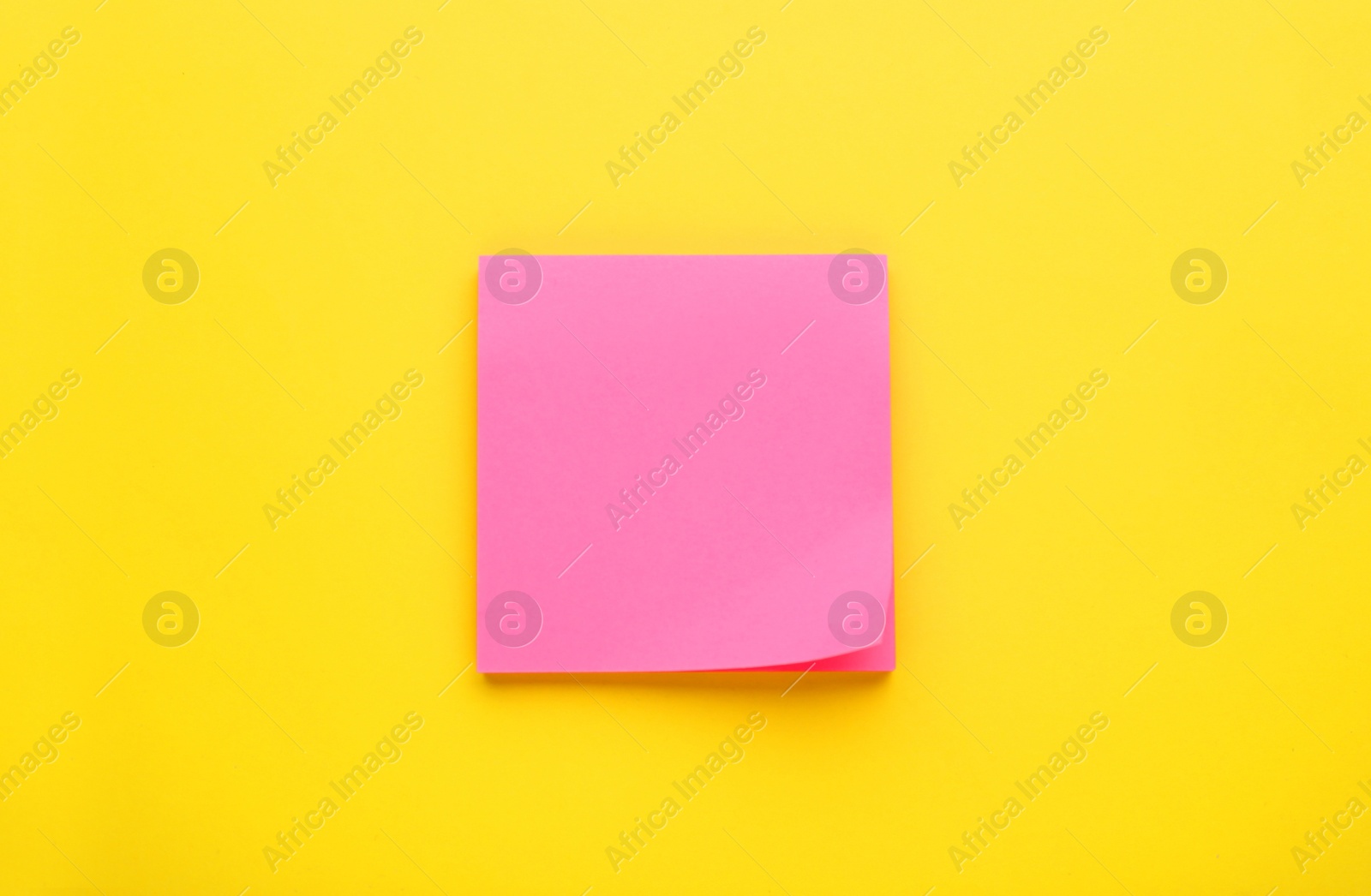 Photo of Paper note on yellow background, top view