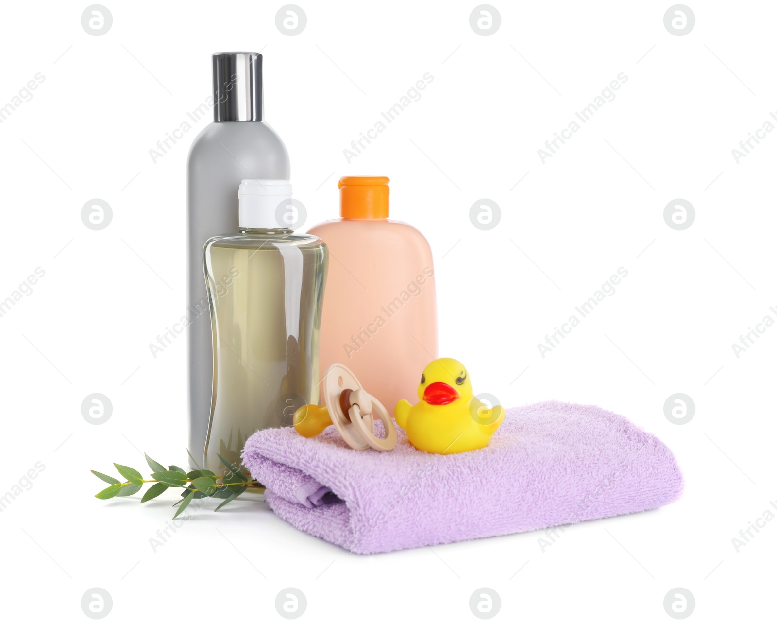 Photo of Bottle of baby oil, other cosmetic products and accessories on white background