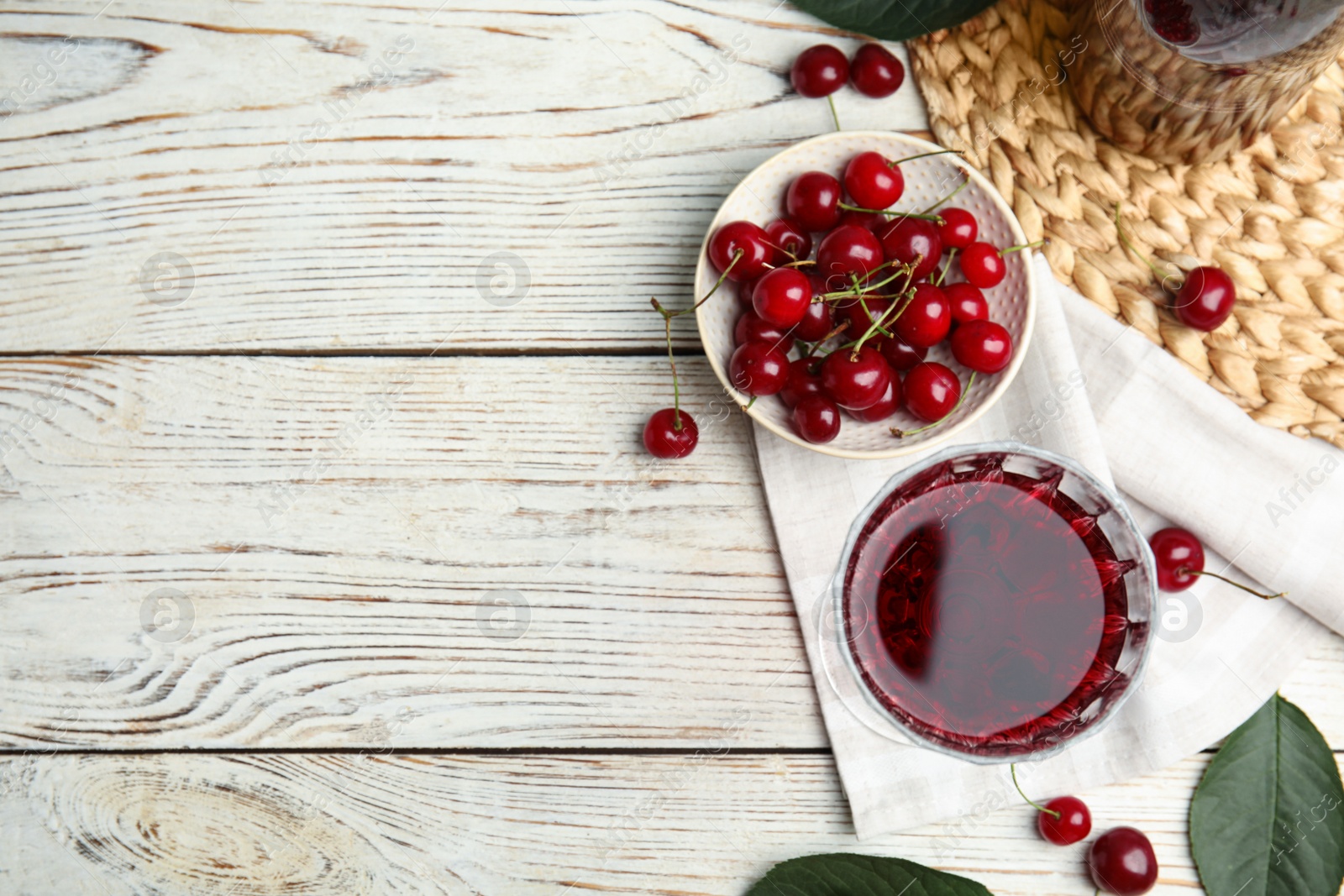 Photo of Delicious cherry wine with ripe juicy berries on white wooden table, flat lay. Space for text