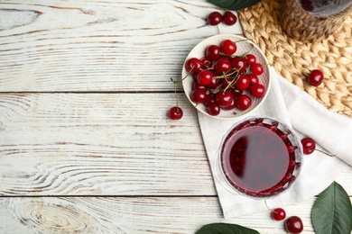 Photo of Delicious cherry wine with ripe juicy berries on white wooden table, flat lay. Space for text