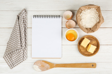 Photo of Flat lay composition with eggs and other ingredients  on white wooden table, space for text. Baking pie