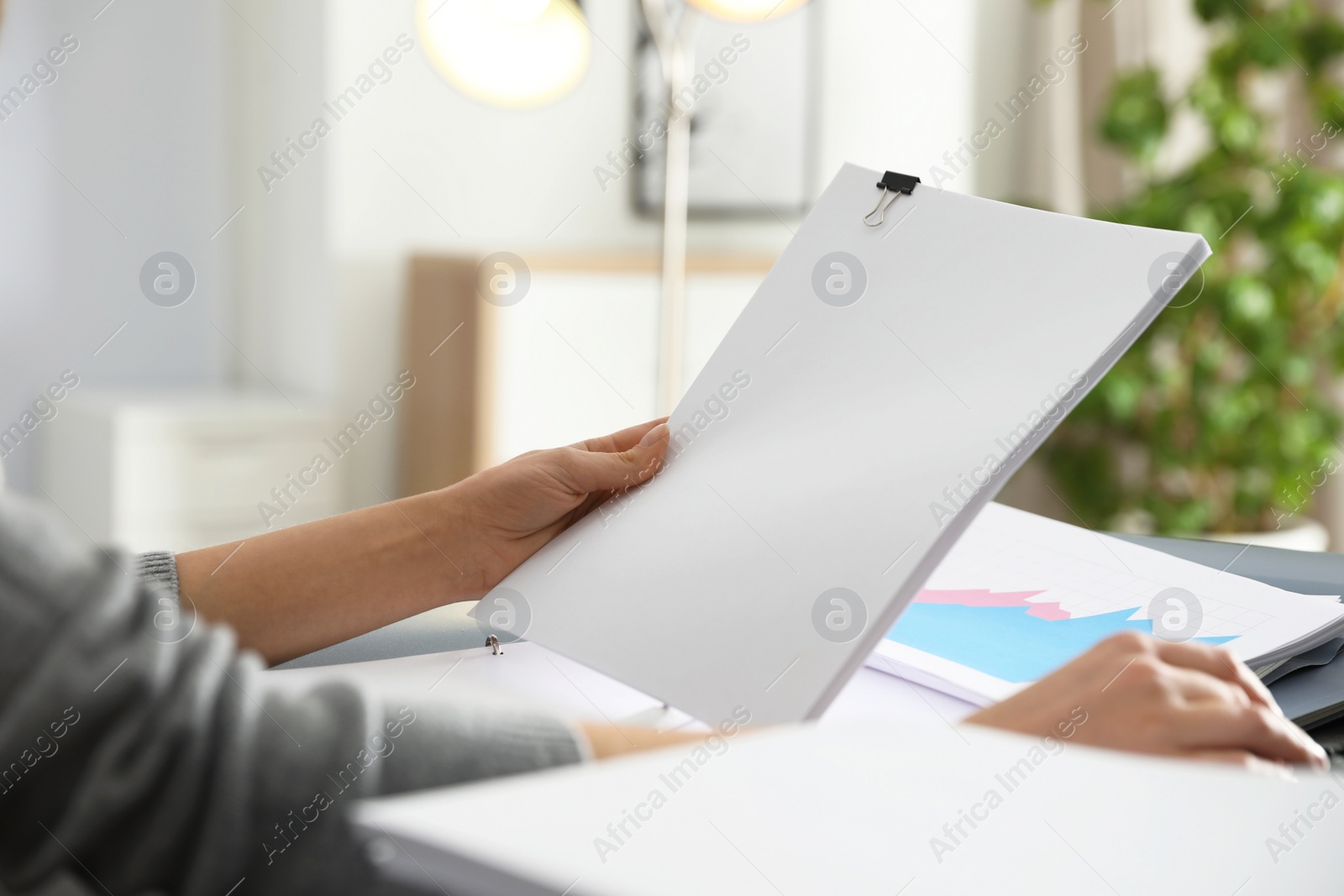 Photo of Office employee working with documents at table, closeup. Space for text