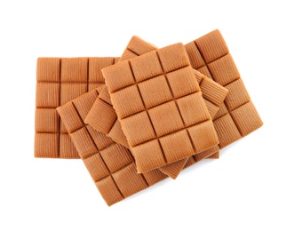 Photo of Delicious caramel candies on white background