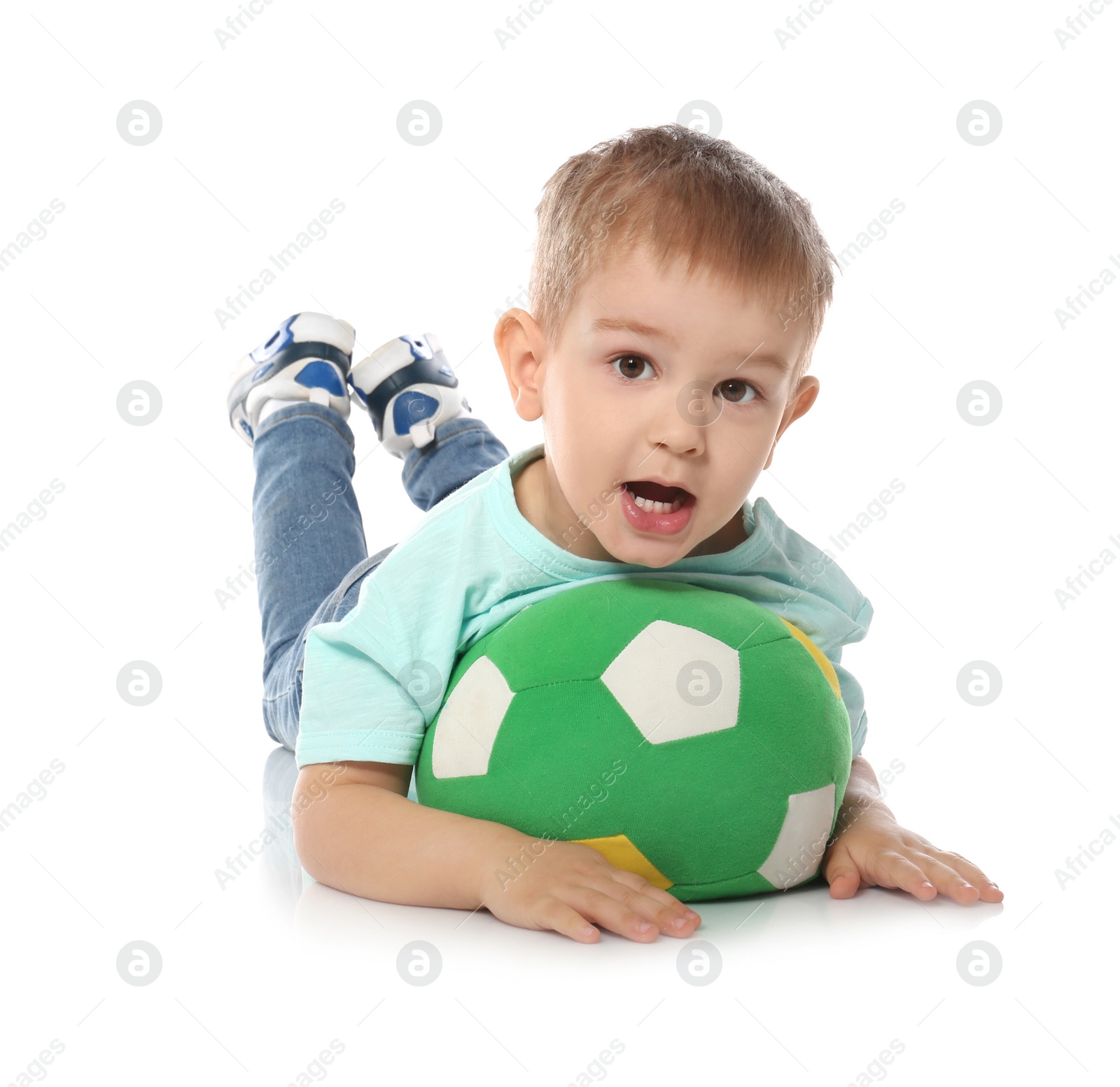 Photo of Cute little child with soft soccer ball on white background. Playing indoors