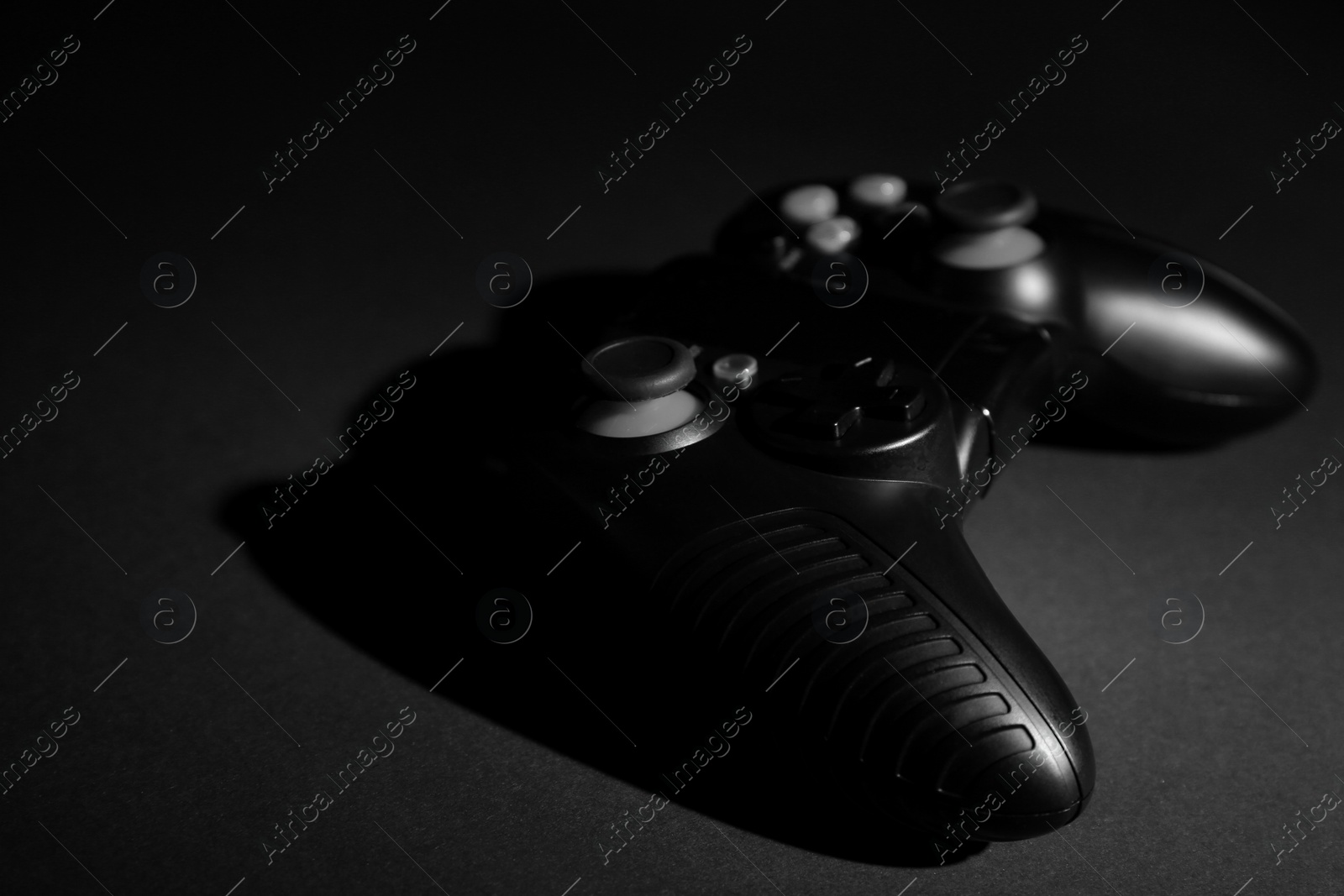 Photo of Video game controller on black background, space for text