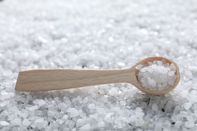 Photo of Natural salt and wooden spoon, closeup view