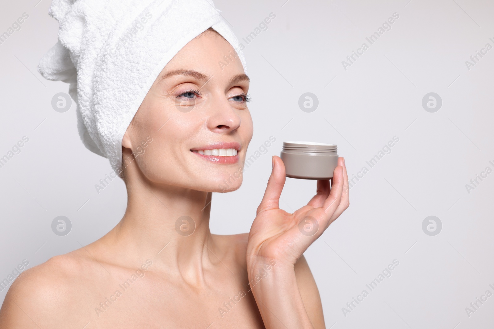 Photo of Woman with jar of body cream on white background, space for text