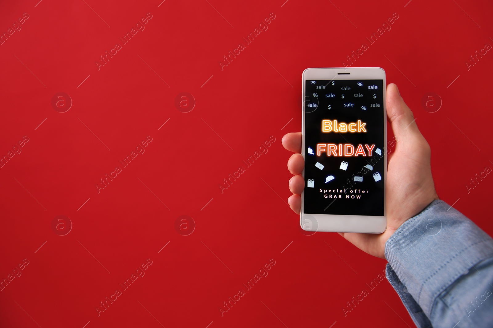 Photo of Man shopping online using smartphone on red background, space for text. Black Friday Sale