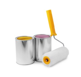 Photo of Cans with different paints and roller on white background