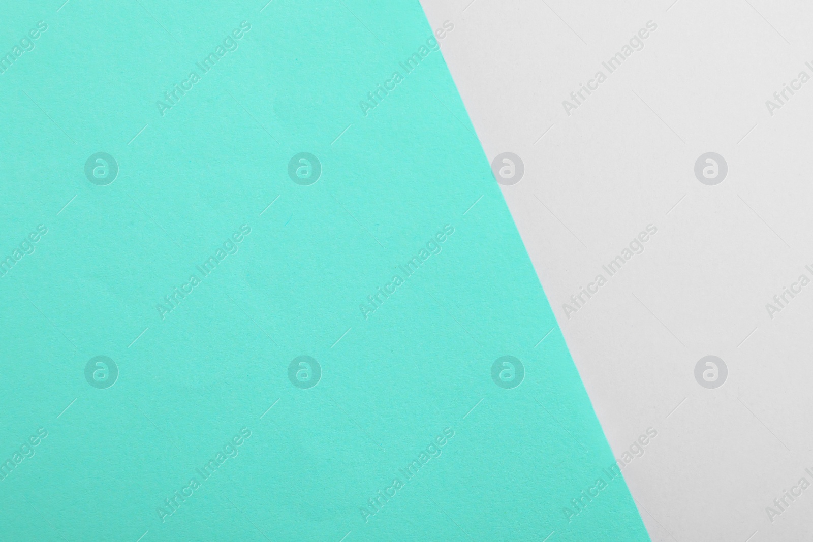 Photo of Turquoise and grey paper sheets as colorful background, top view