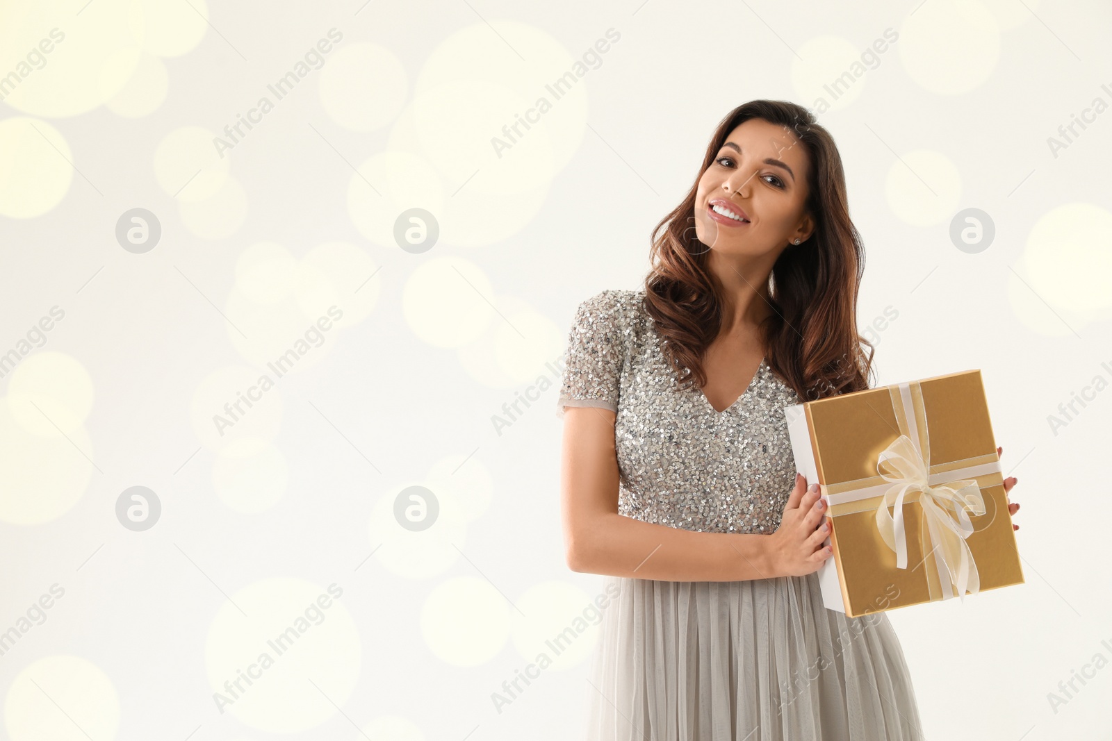 Photo of Beautiful woman with Christmas gift on white background