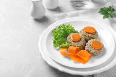 Photo of Plate of traditional Passover (Pesach) gefilte fish on grey background. Space for text