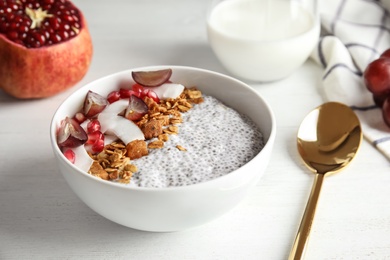 Bowl of tasty chia seed pudding served on table