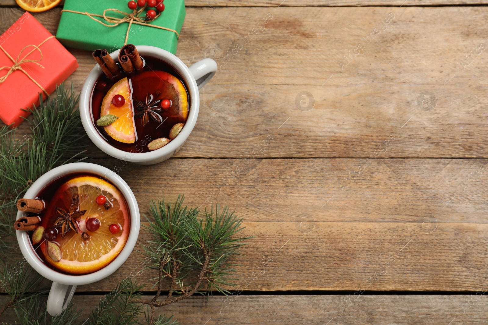 Photo of Flat lay composition with tasty mulled wine on wooden table. Space for text