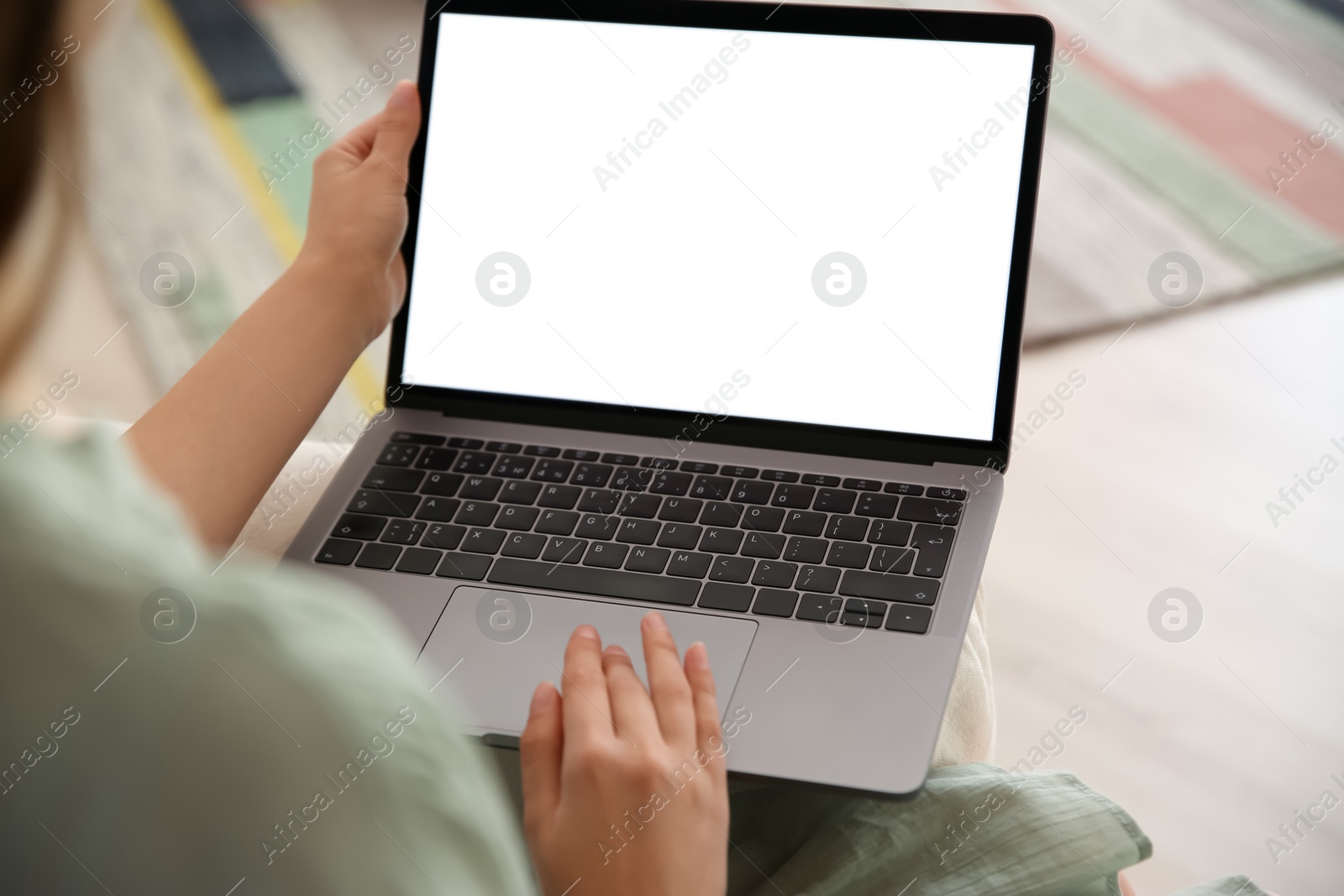 Photo of Woman using laptop at home, closeup. Space for design