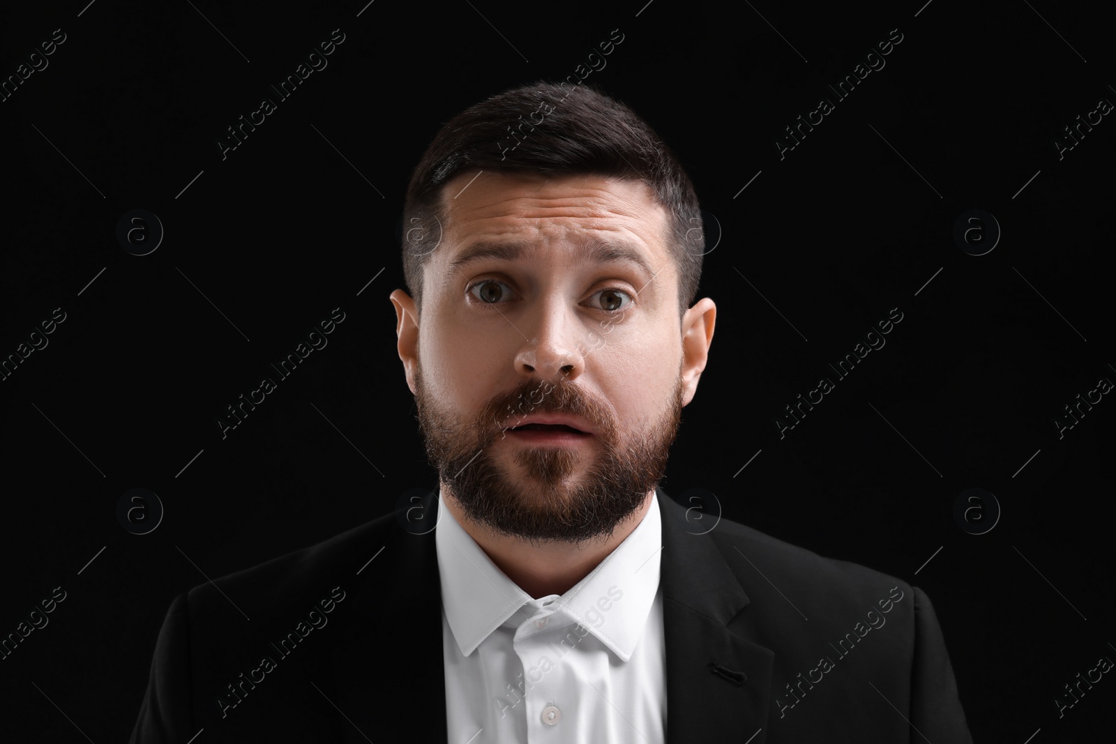 Photo of Personality concept. Emotional man on black background
