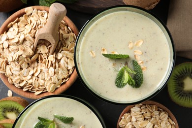 Glass of tasty kiwi smoothie with oatmeal on table, flat lay