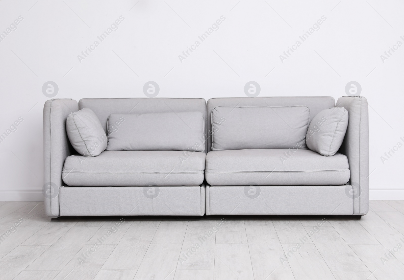 Photo of Room interior with comfortable sofa near white wall