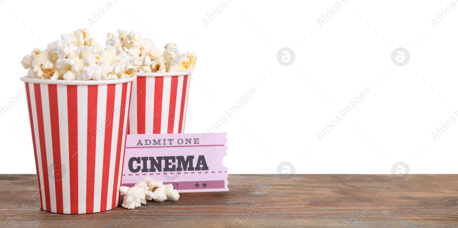 Photo of Cups with delicious popcorn and tickets on wooden table against white background