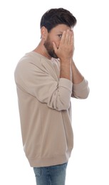 Embarrassed man covering face with hands on white background