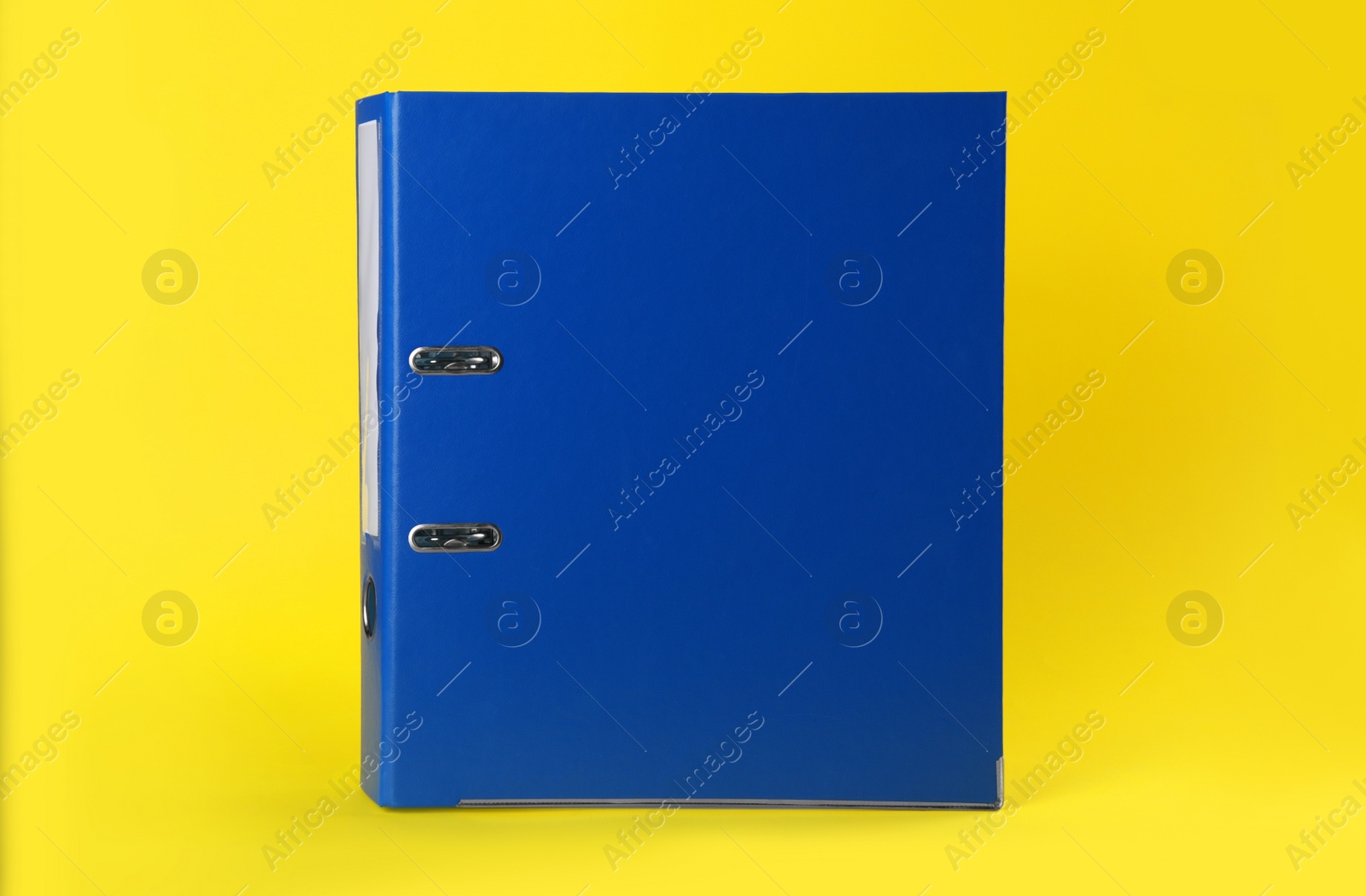 Photo of Blue hardcover office folder on yellow background