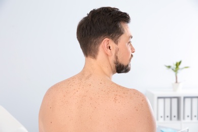 Man with birthmarks in clinic. Visit to dermatologist