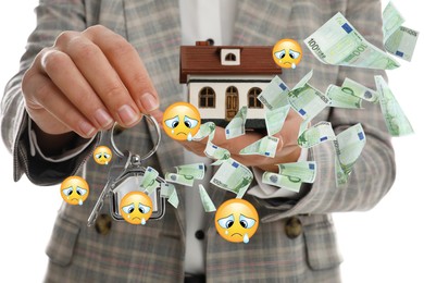 Image of Woman with keys and house model on white background, closeup. Crying face emoji illustrations and flying euro banknotes symbolizing buyer's remorse