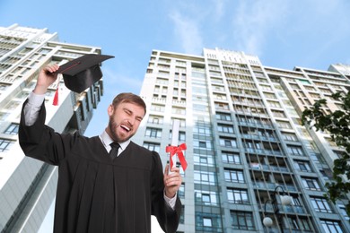 Image of Happy student with graduation hat and diploma outdoors 