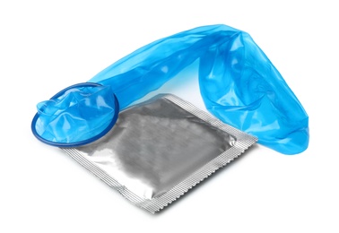 Unrolled blue condom and package on white background. Safe sex