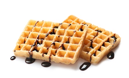 Photo of Delicious waffles with chocolate syrup on white background