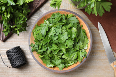 Photo of Flat lay composition with fresh green parsley on wooden table