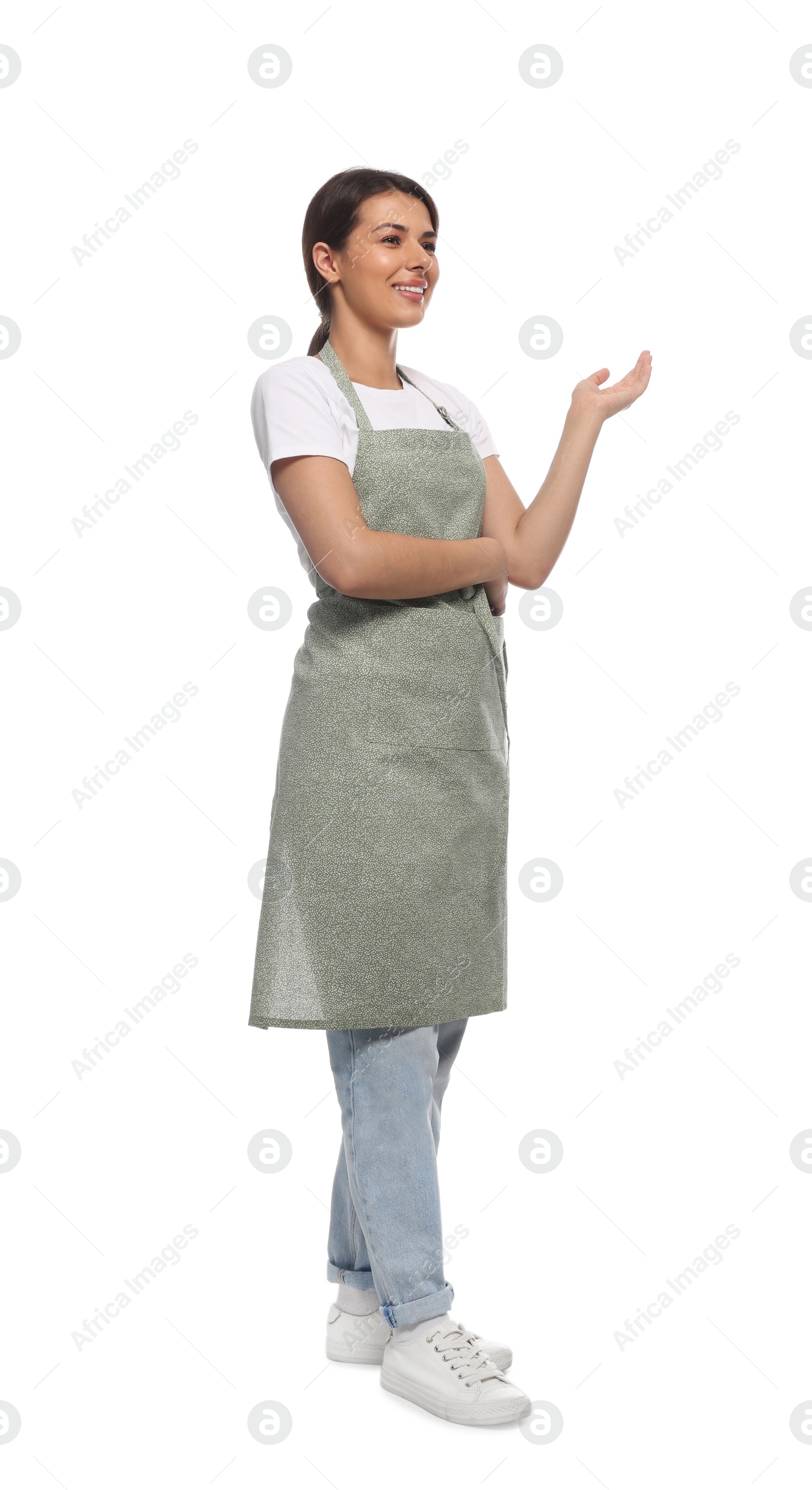 Photo of Young woman in green apron on white background