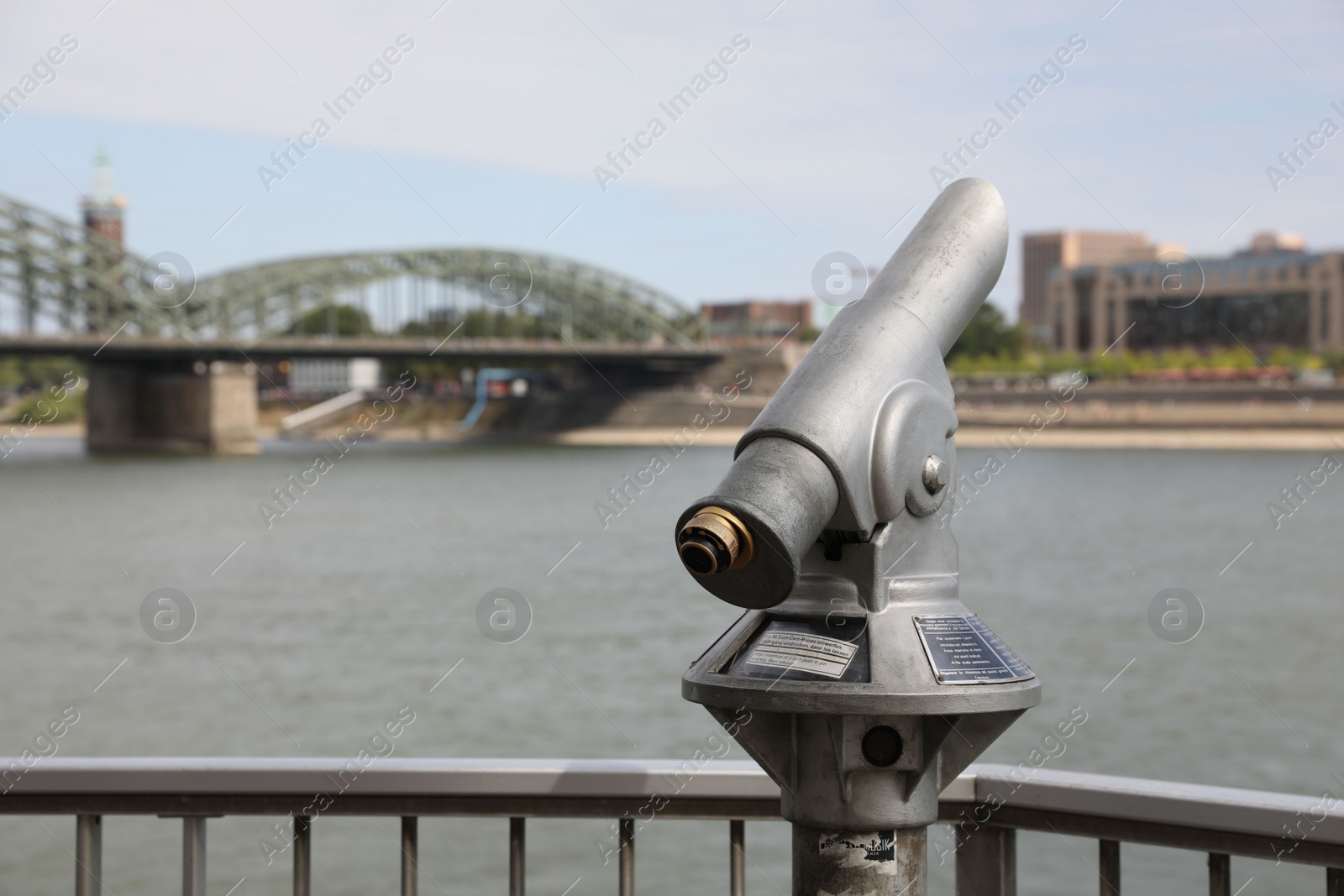 Photo of Cologne, Germany - August 28, 2022: Modern public telescope near river on sunny day