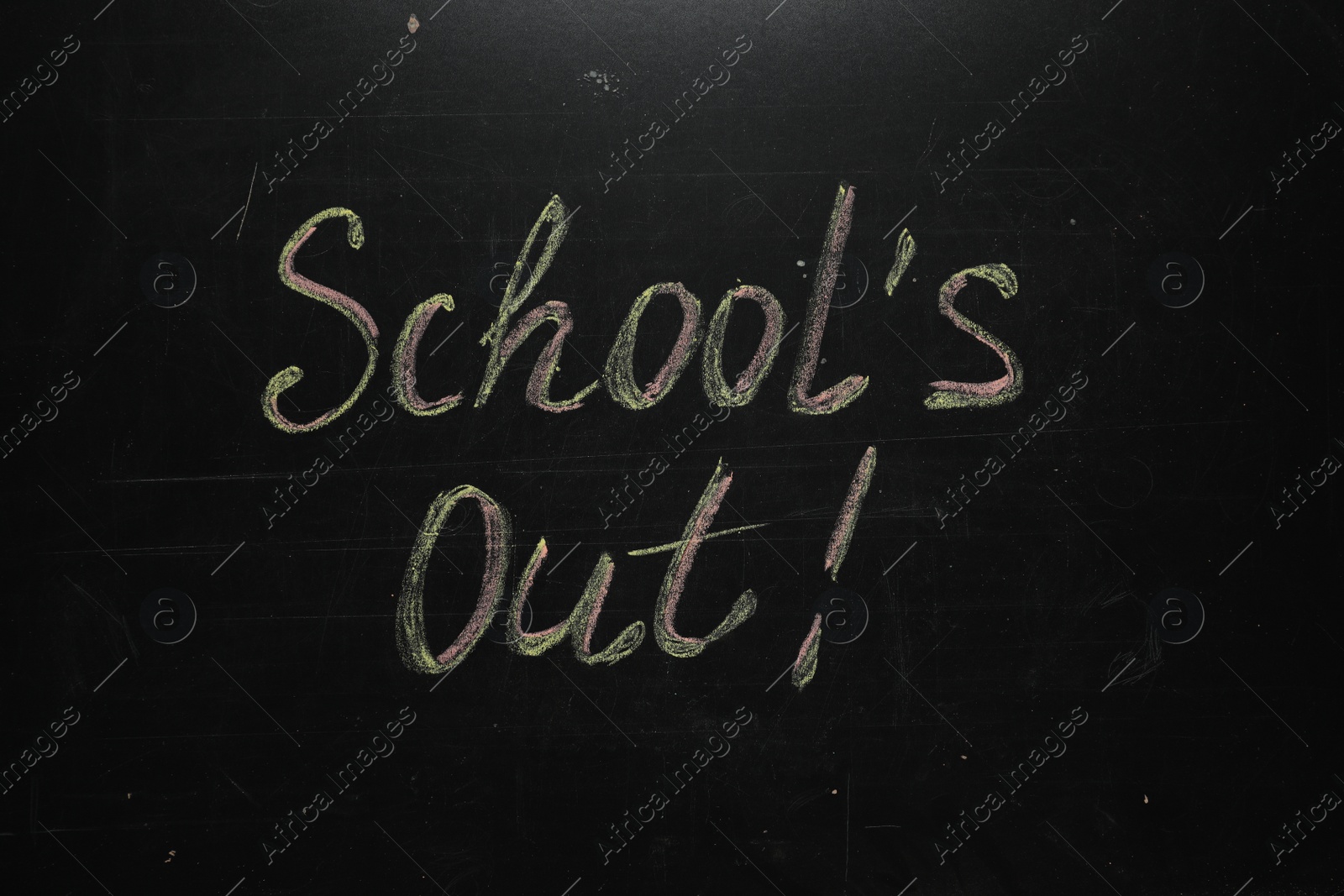 Photo of Text SCHOOL'S OUT written on blackboard. Summer holidays