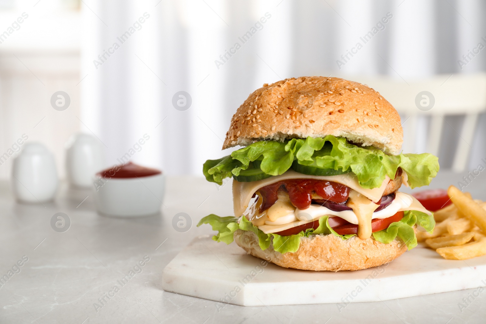 Photo of Board with tasty burger on table. Space for text