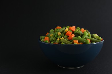 Photo of Mix of fresh vegetables in bowl on black background. Space for text