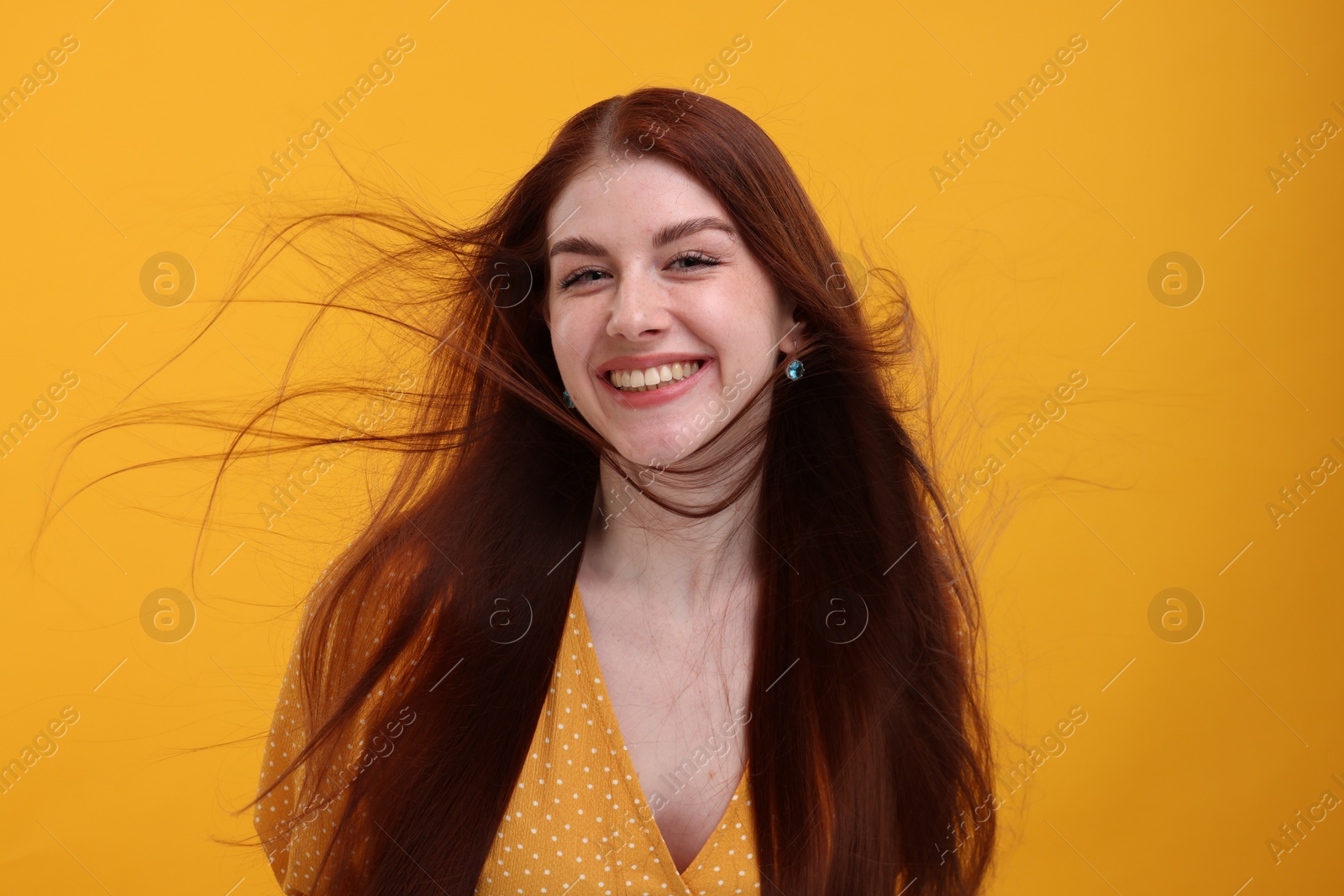 Photo of Portrait of smiling woman on yellow background