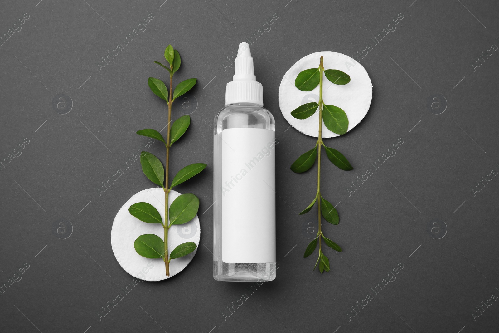 Photo of Flat lay composition with makeup remover on dark grey background
