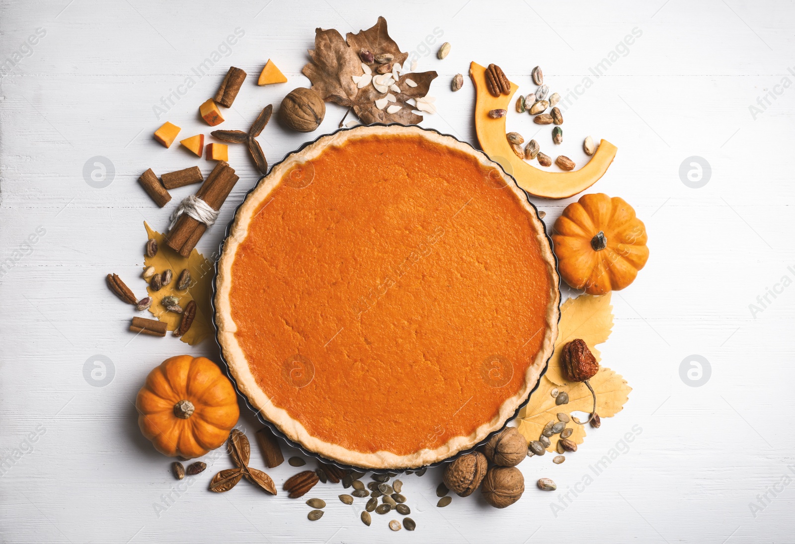 Photo of Flat lay composition with delicious homemade pumpkin pie on white wooden table